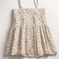 Floral dress with thin straps on a light gray background