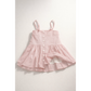 Pink dress with button details on a light gray background