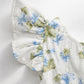 Josie Romper Flutter Sleeve view Floral patterned fabric on a white background