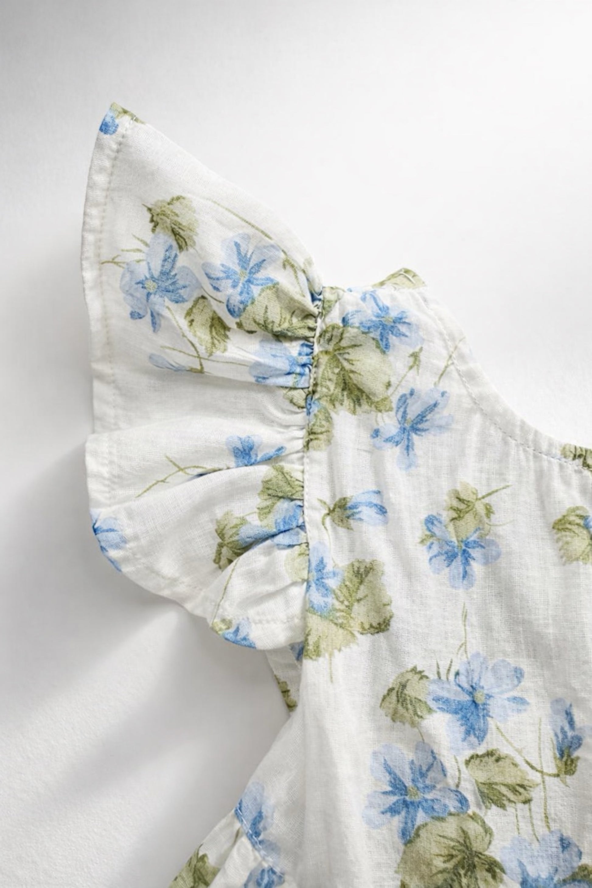 Josie Romper Flutter Sleeve view Floral patterned fabric on a white background