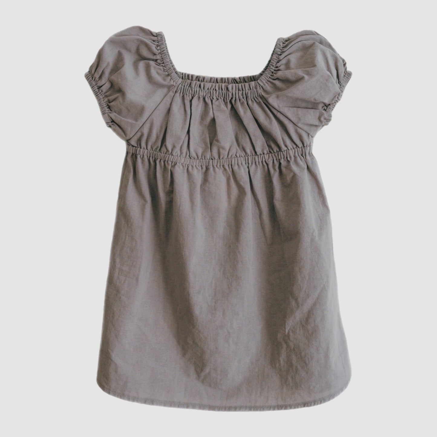 Gray dress with ruffled sleeves on a light gray background