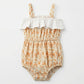 Floral baby romper with ruffled top on a white background