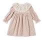 Pink floral dress with a white ruffled collar on a white background