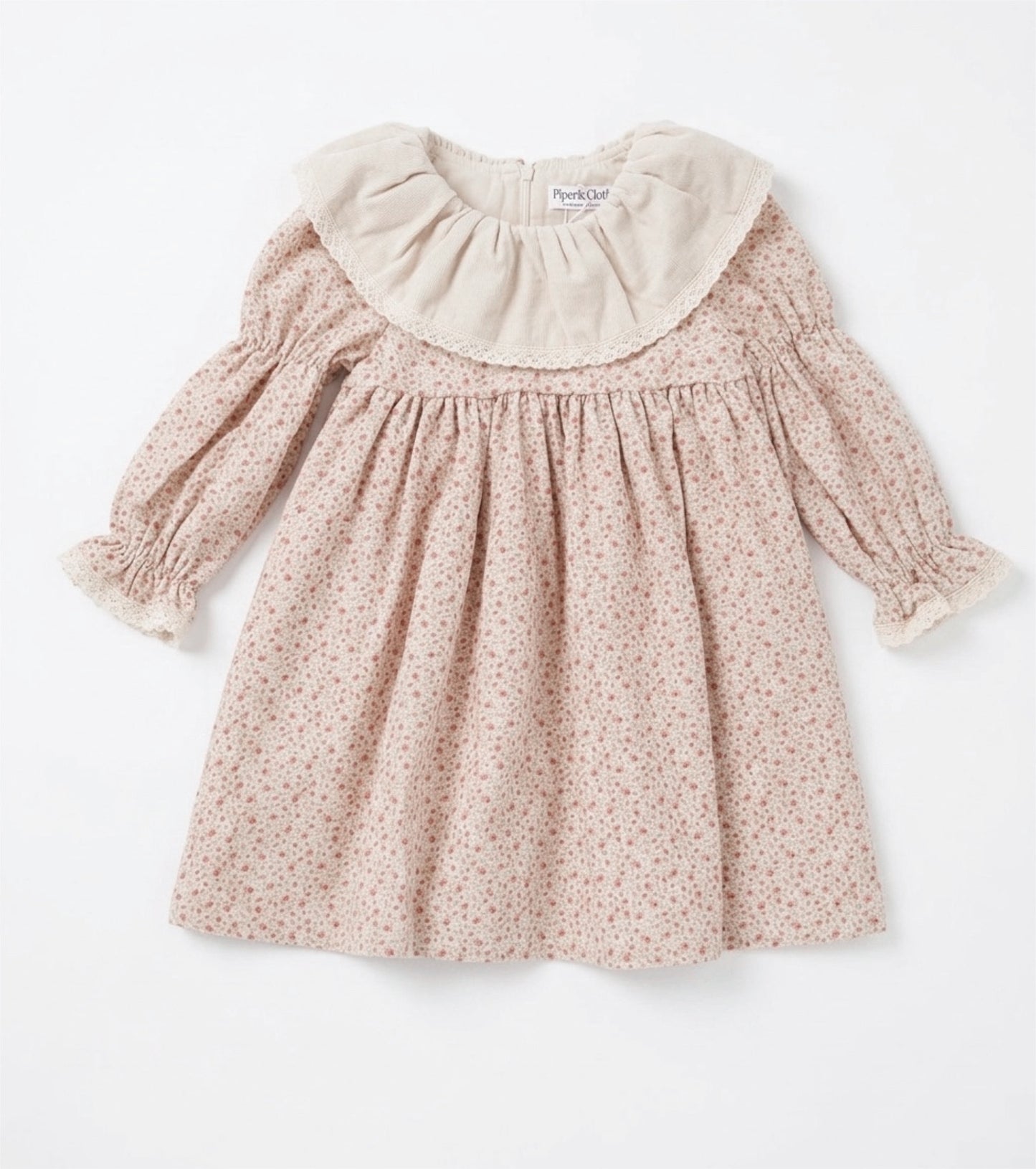 Pink floral dress with a white collar on a white background