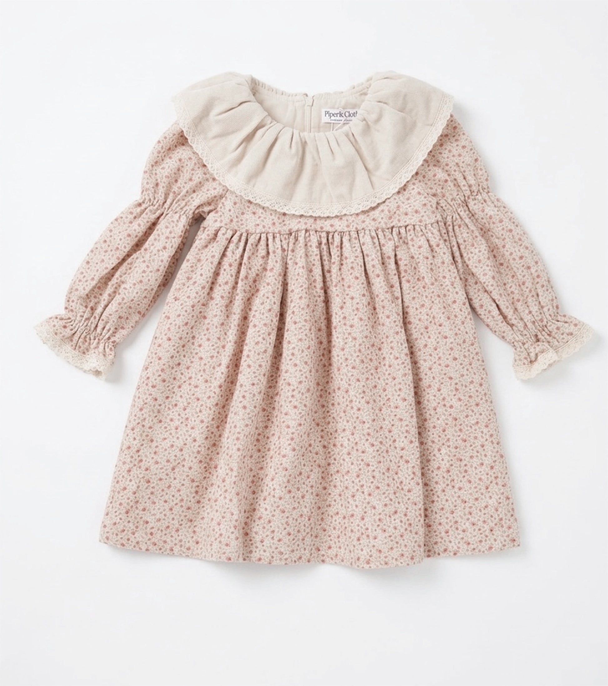 Pink floral dress with a white collar on a white background