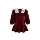Maroon dress with white collar on a white background