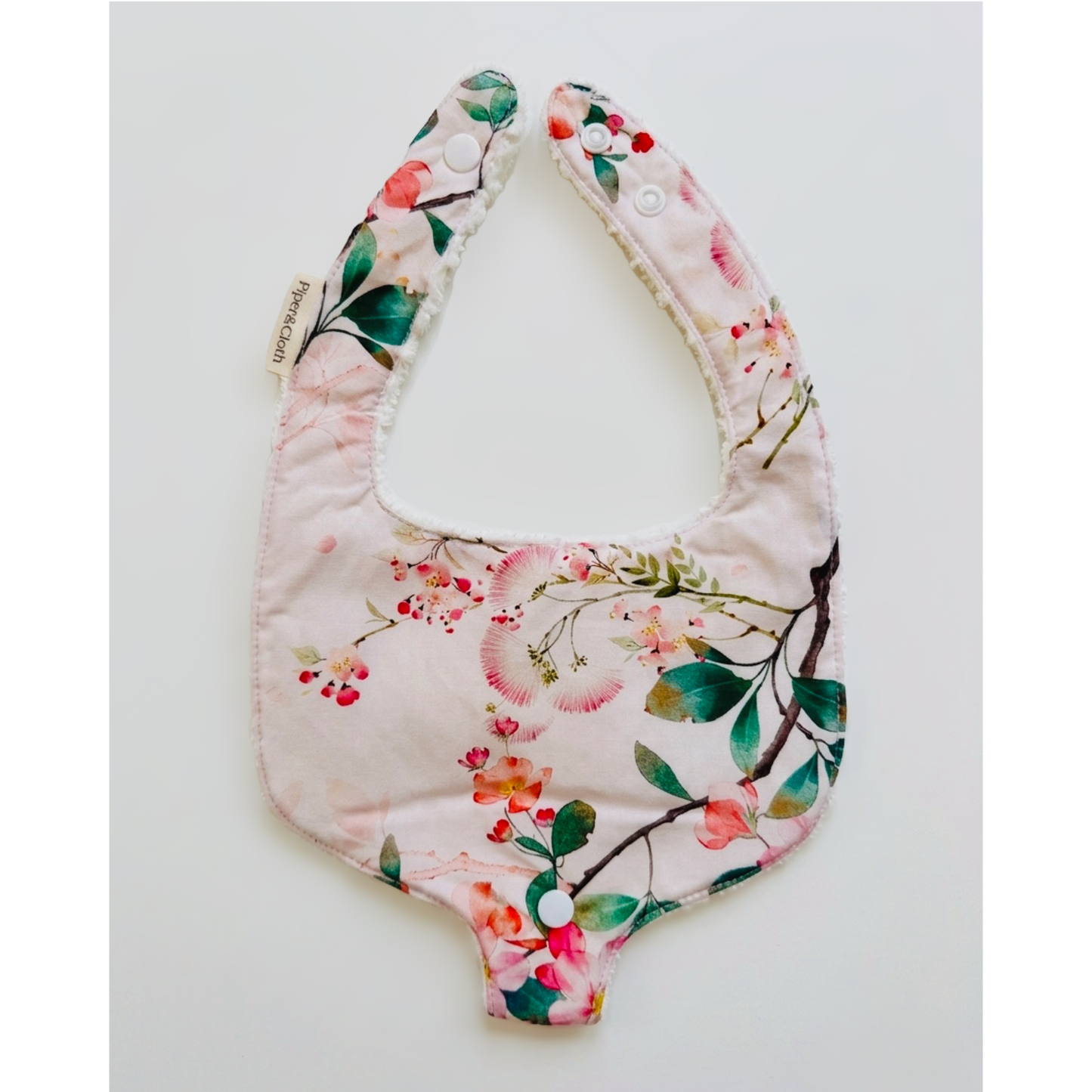 Floral-patterned baby bib on a white background