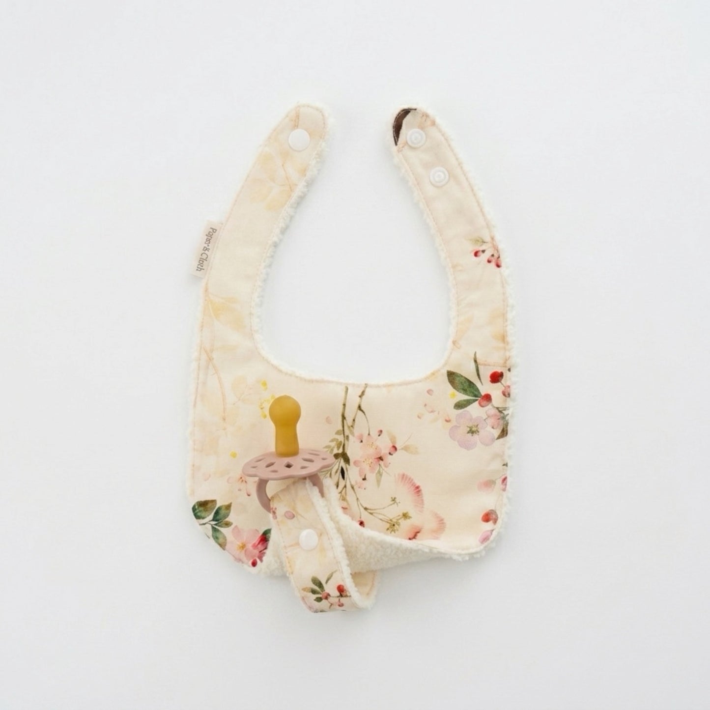 Floral-patterned baby bib on a white background