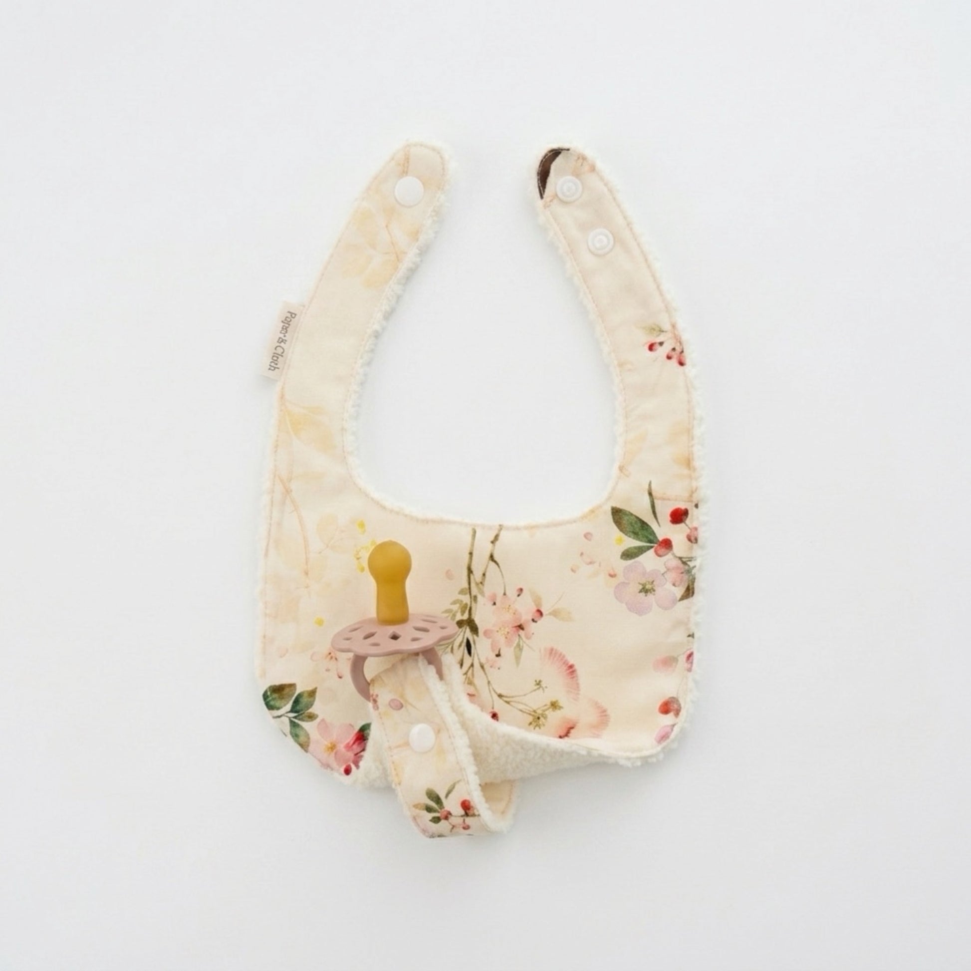 Floral-patterned baby bib on a white background