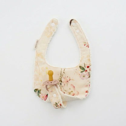 Floral-patterned baby bib on a white background