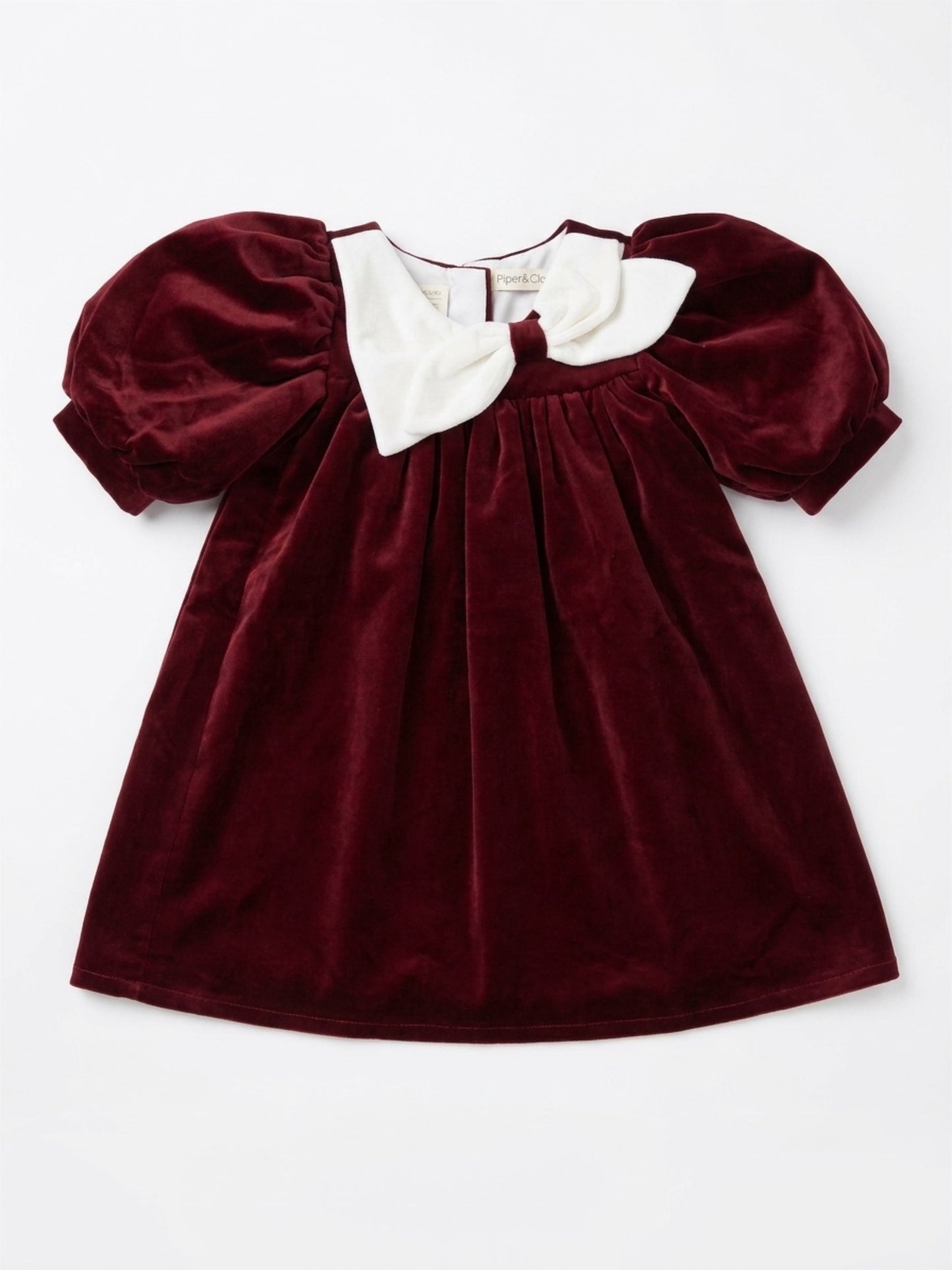 Maroon velvet dress with white collar on a white background
