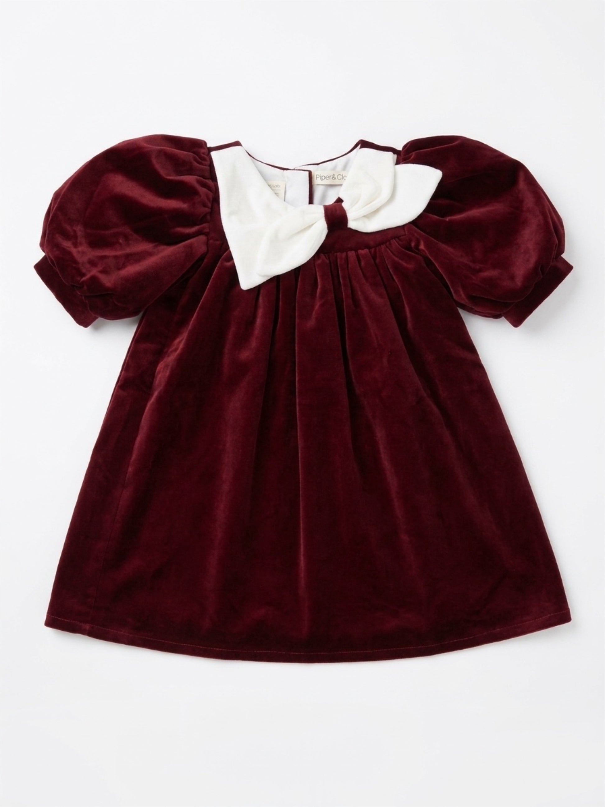Maroon velvet dress with white collar on a white background
