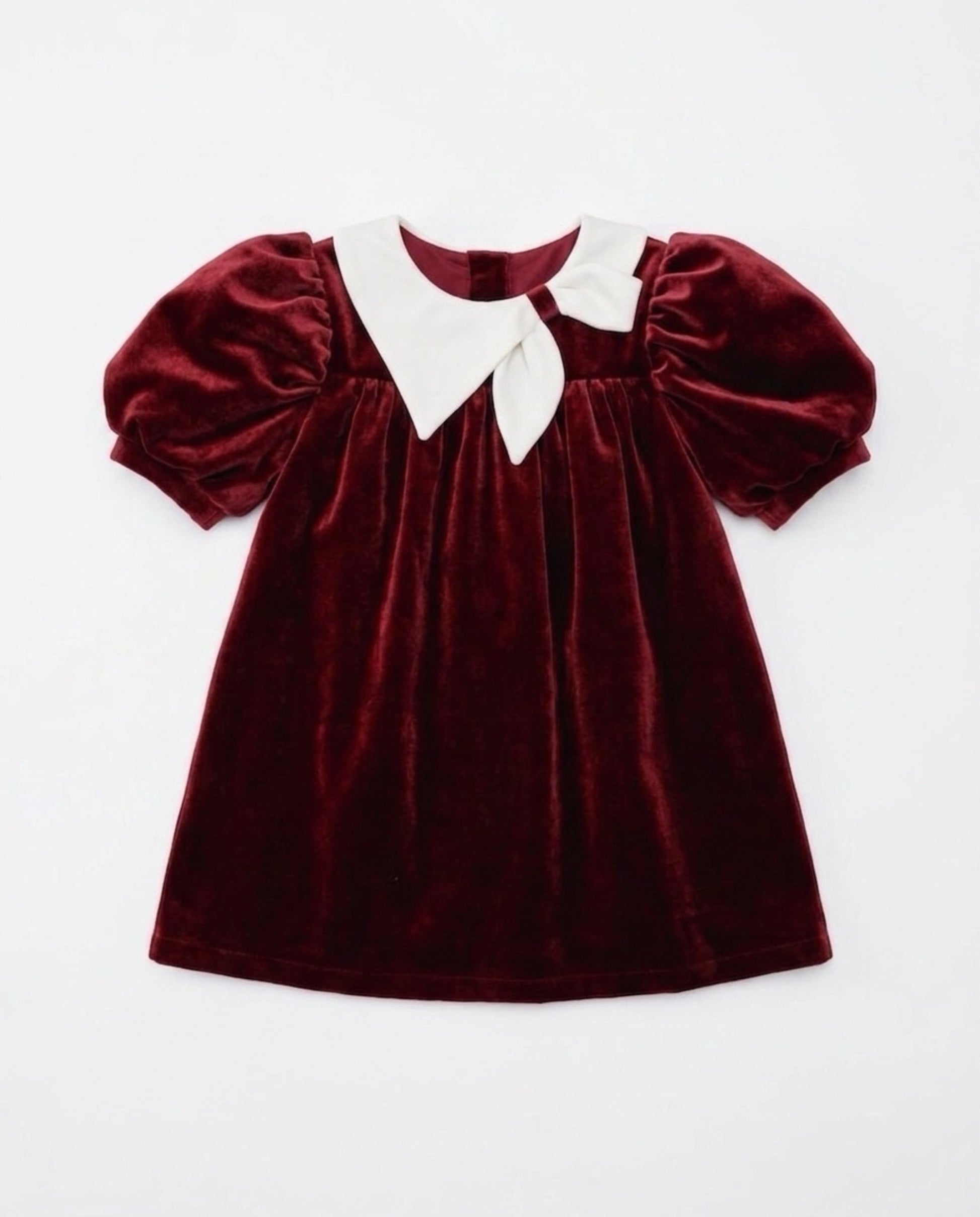 Red velvet dress with white collar on a light gray background