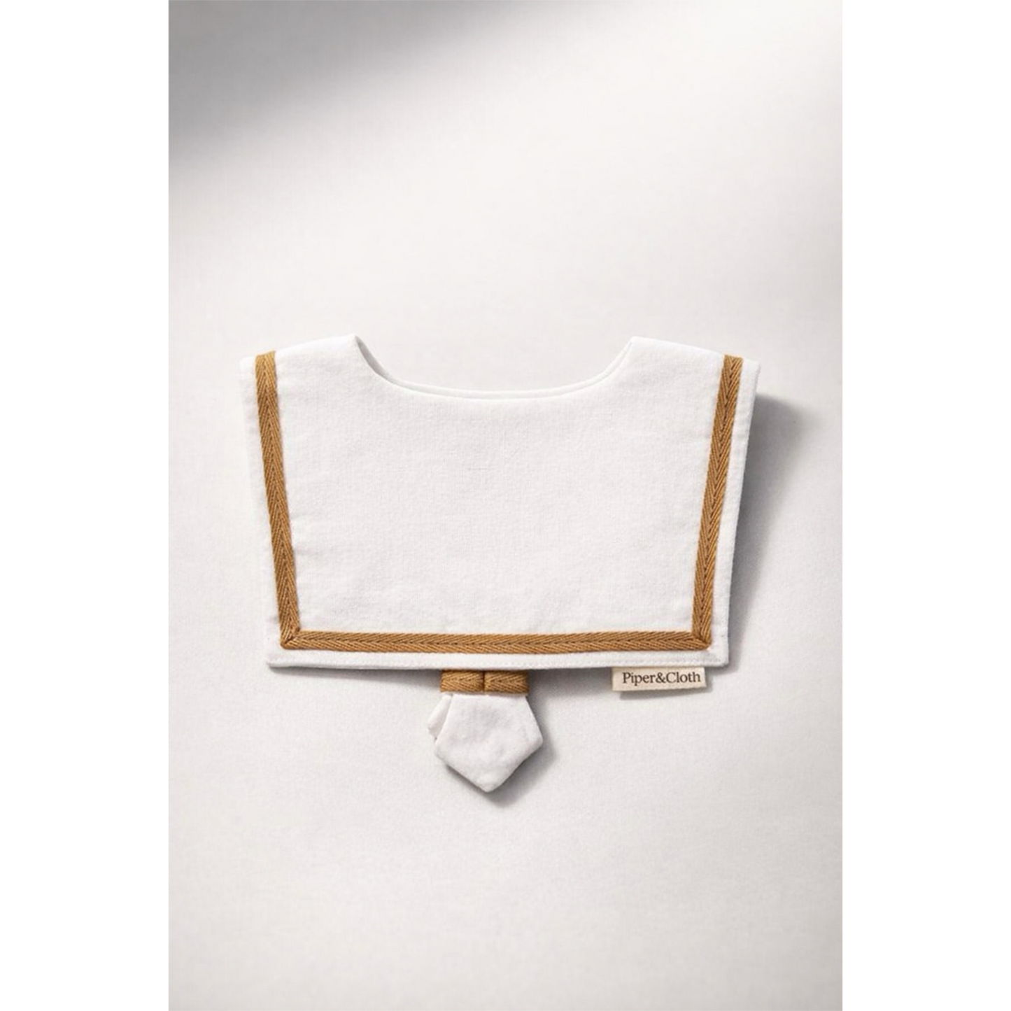 White bib with brown trim on a white background