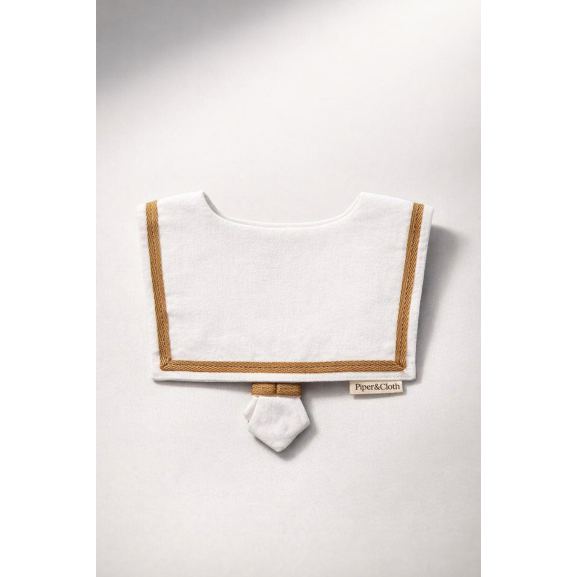 White bib with brown trim on a white background