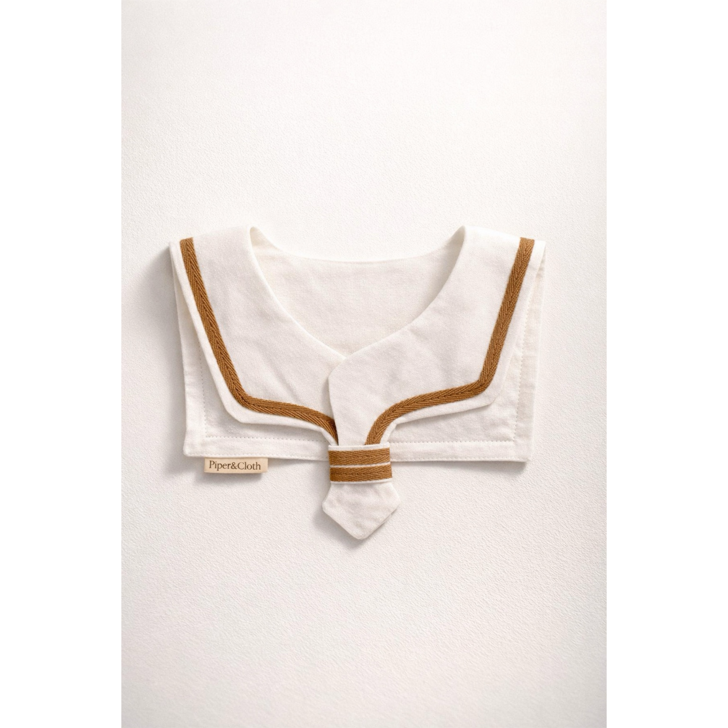 White sailor collar with brown trim on a white background