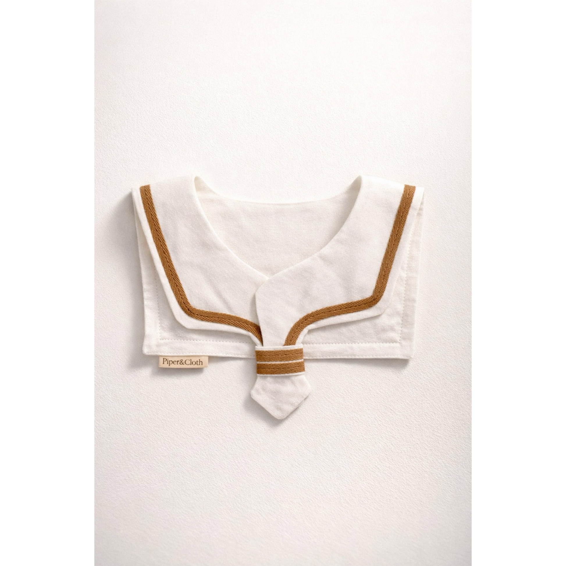 White sailor collar with brown trim on a white background