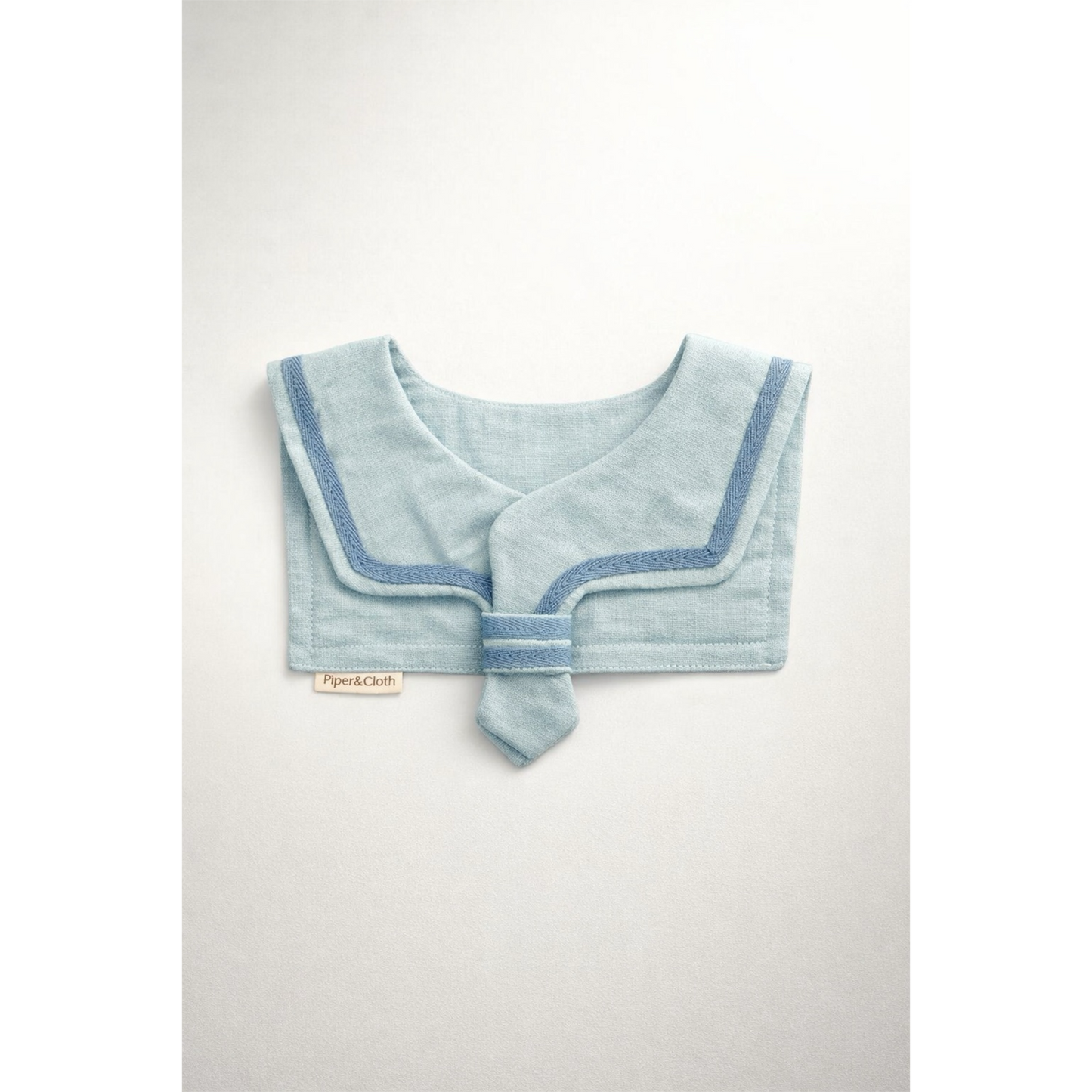 Light blue baby bib with a contrasting trim on a white background
