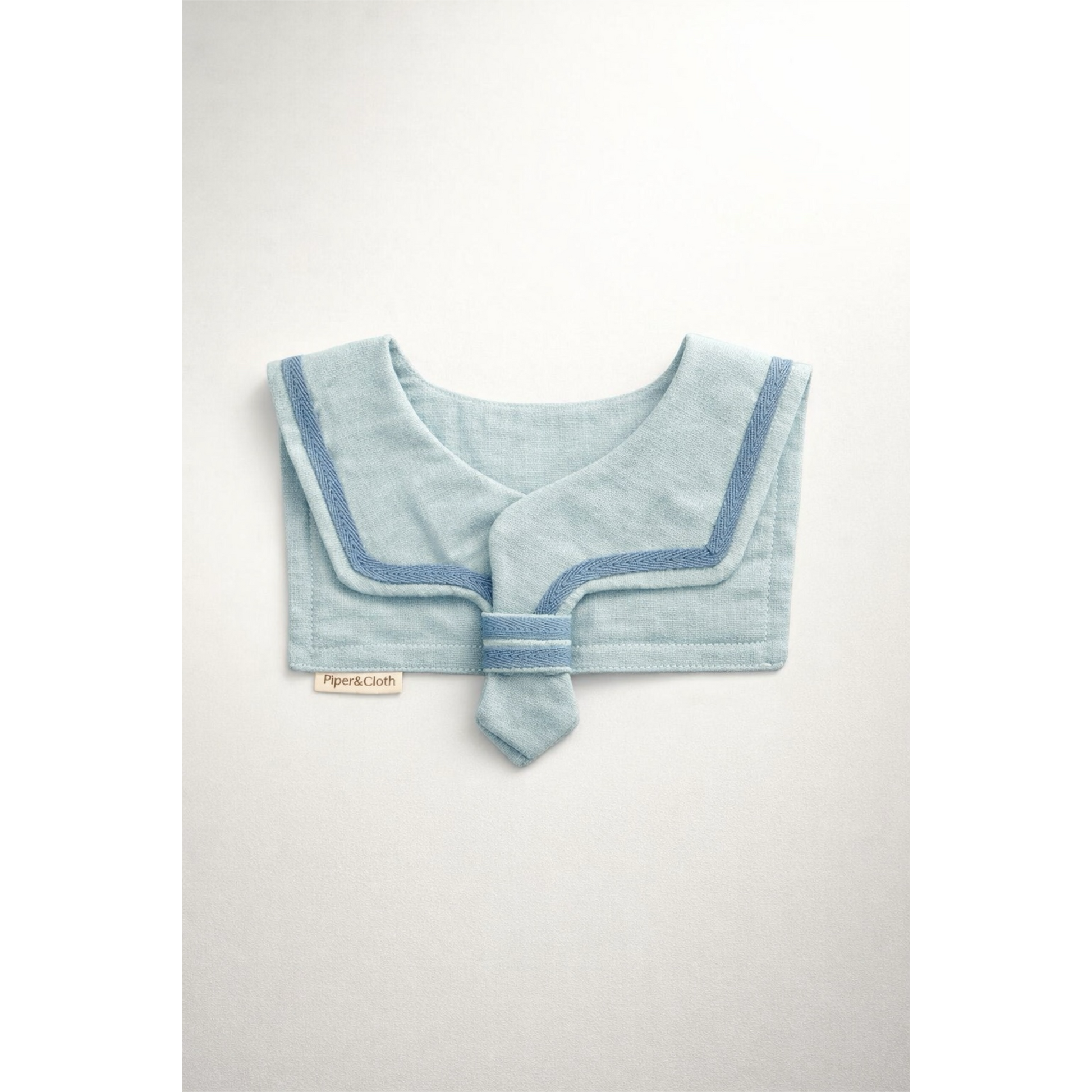 Light blue baby bib with a contrasting trim on a white background