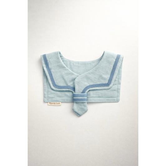 Light blue baby bib with a contrasting trim on a white background
