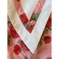 Close-up of a quilt with floral patterns and a white border.
