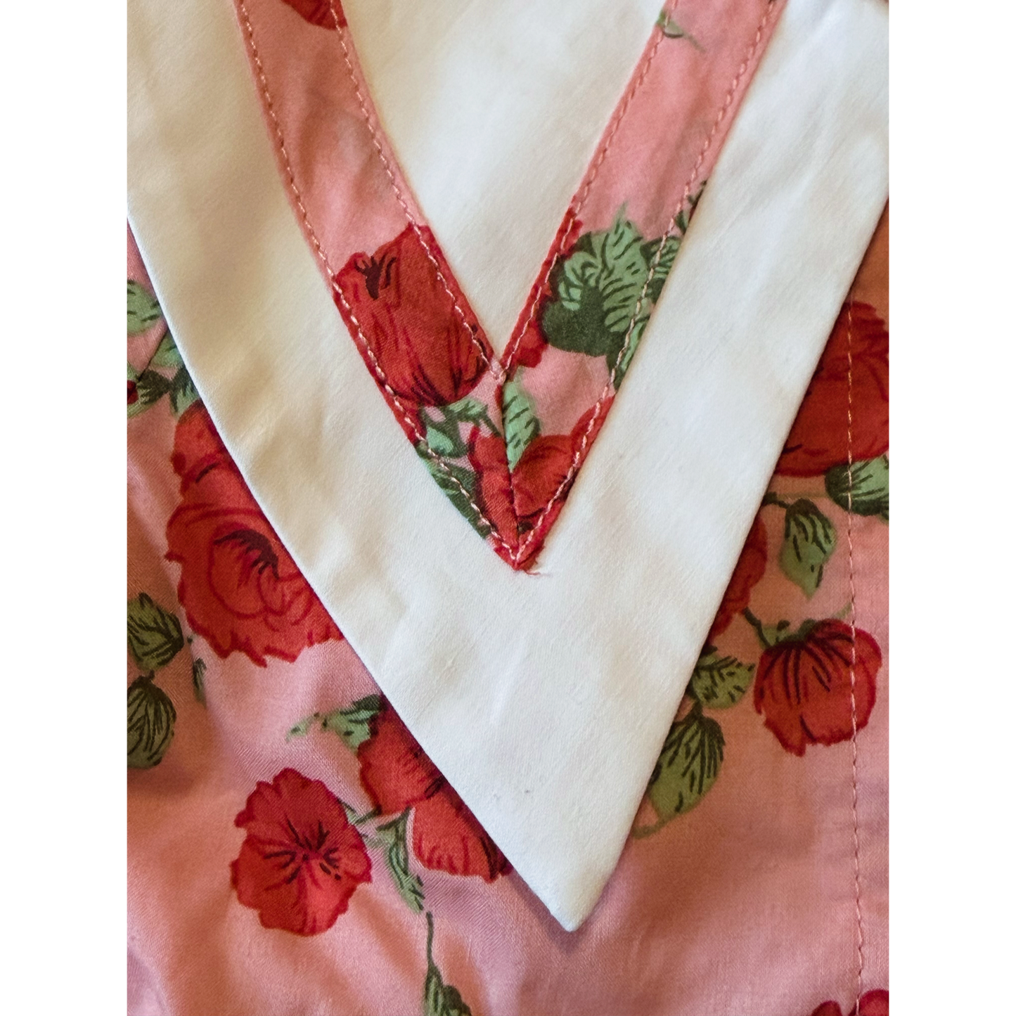 Close-up of a quilt with floral patterns and a white border.