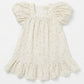 White baby dress with ruffled sleeves on a light gray background