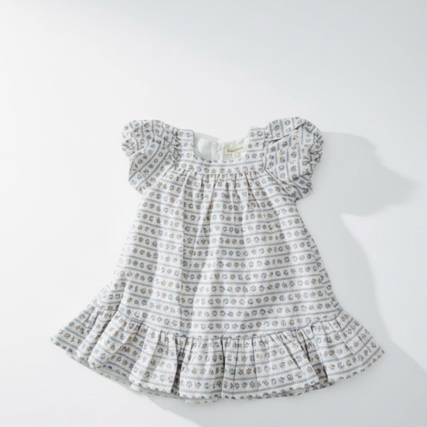 Baby dress with a pattern on a white background