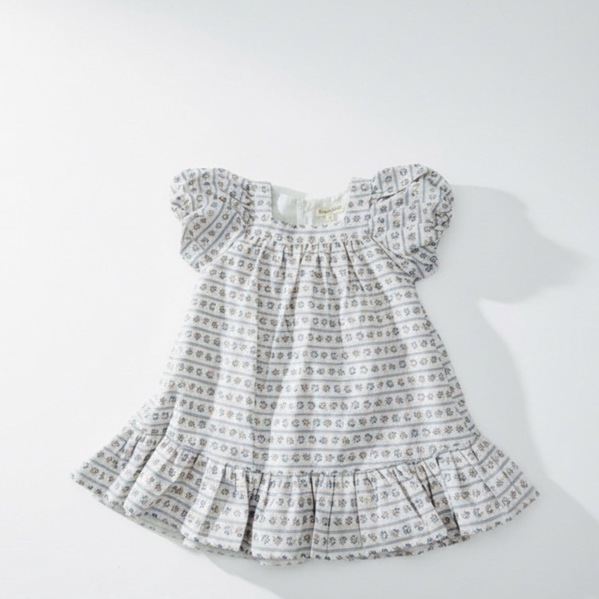 Baby dress with a pattern on a white background